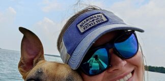 a woman and her dog are on a boat