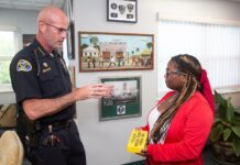 a police officer talking to a woman in a room