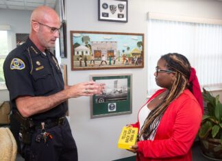 a police officer talking to a woman in a room