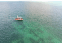a boat in the middle of the ocean