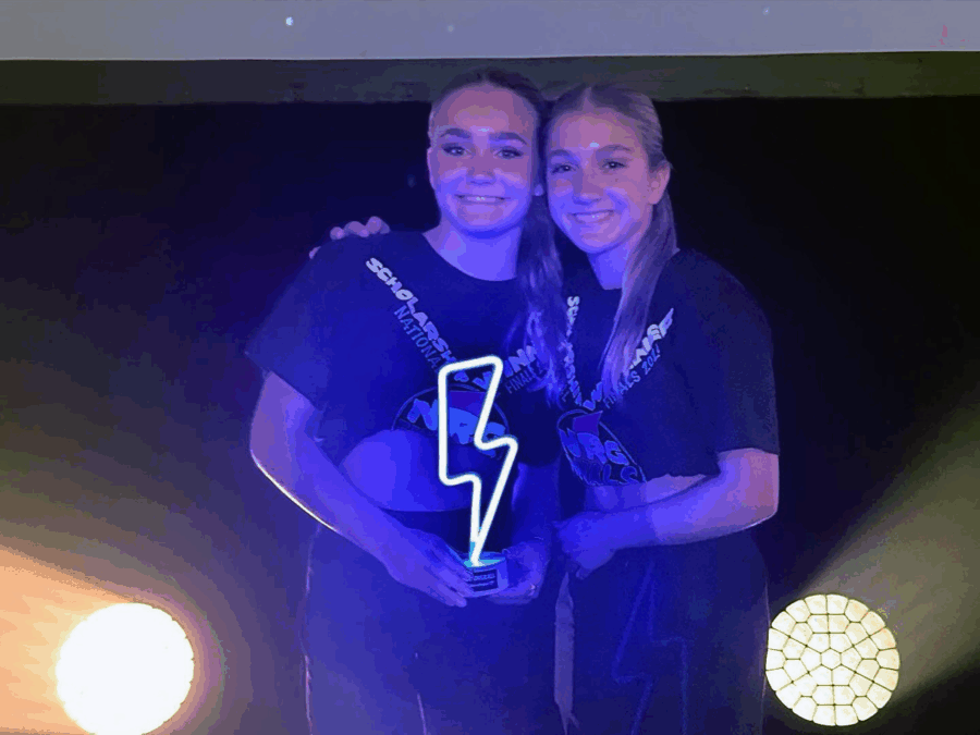 a couple of people standing next to each other on a stage