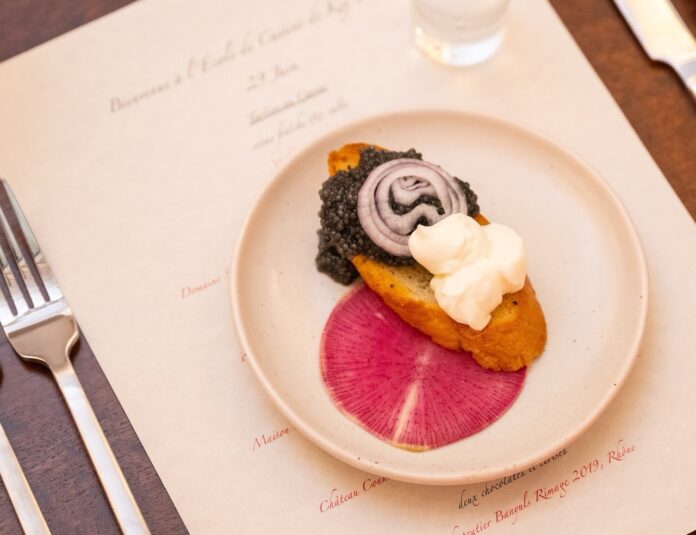 Caviar Nick Doll Large a white plate topped with food on top of a table