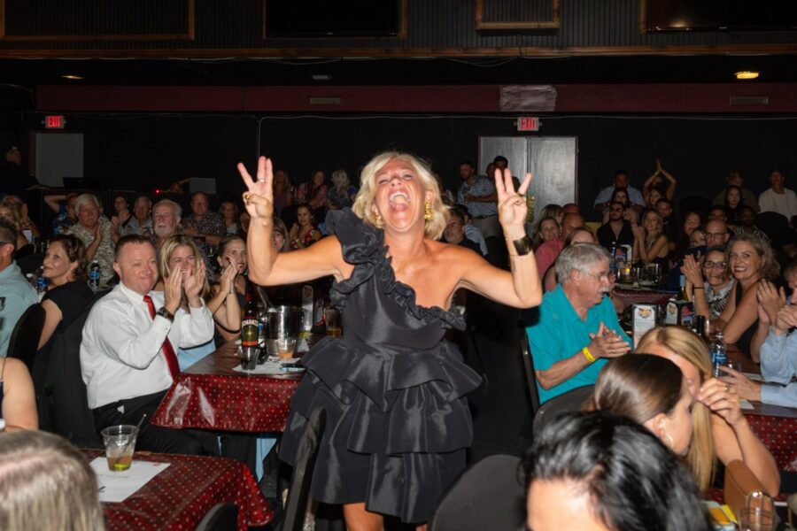 a woman standing in front of a crowd of people