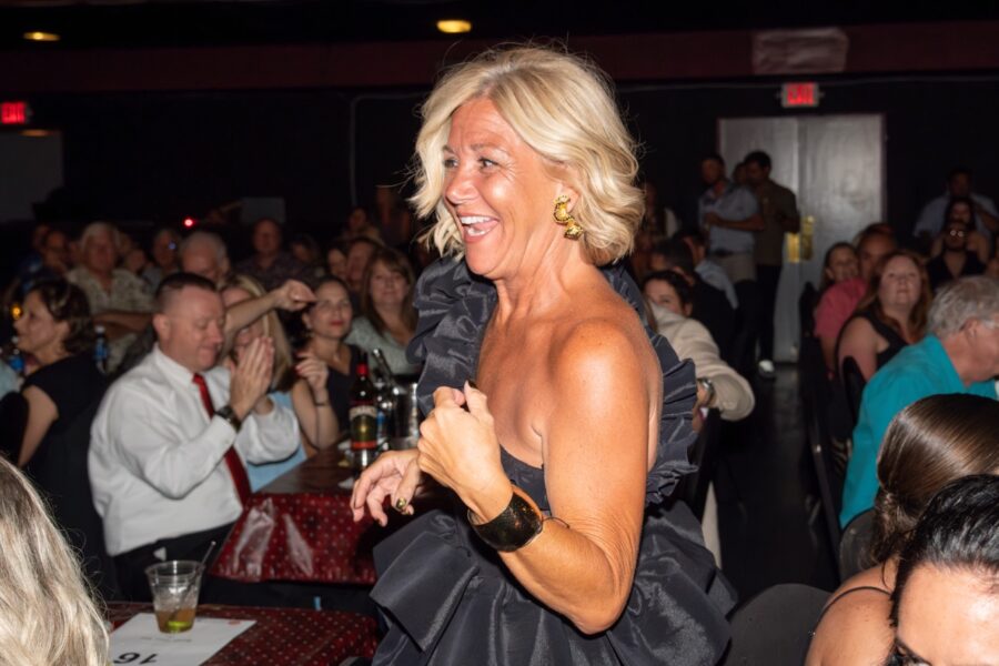 a woman standing in front of a crowd of people
