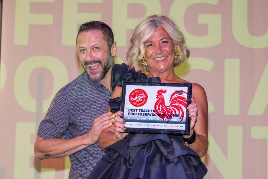 a man and a woman holding an award