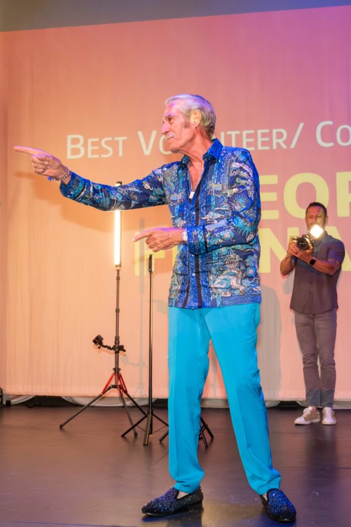 a man standing on a stage with a microphone