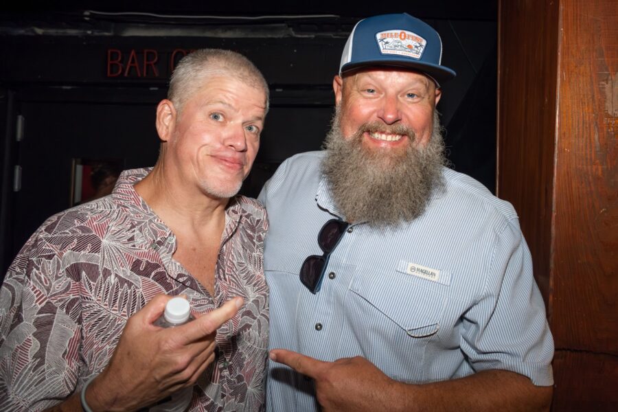 a couple of men standing next to each other