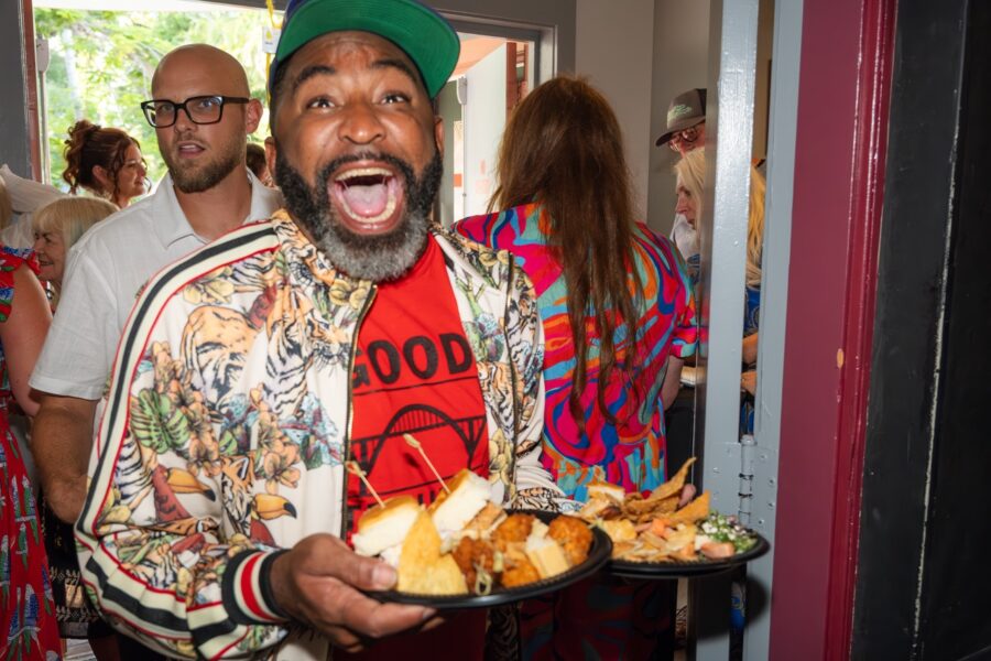 a man holding a plate of food in his hands