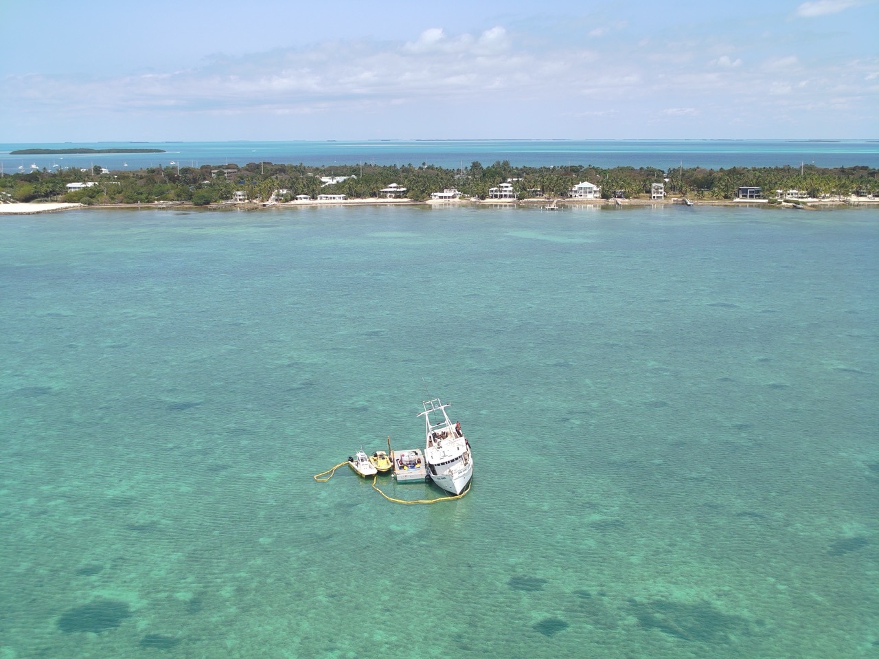 a small boat floating in the middle of a body of water