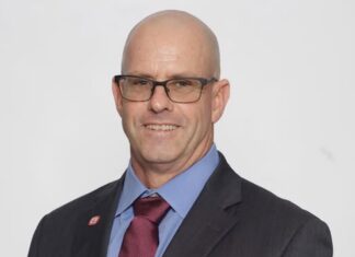 a man in a suit and tie posing for a picture