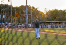a group of people on a field playing baseball