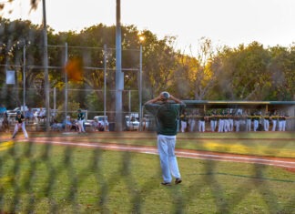 a group of people on a field playing baseball