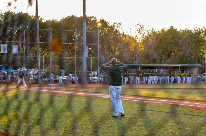 a group of people on a field playing baseball