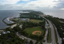 an aerial view of a baseball field next to the ocean