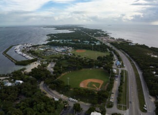 an aerial view of a baseball field next to the ocean