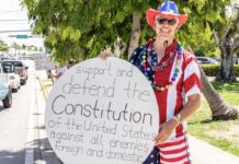 a man in a patriotic outfit holding a sign