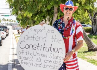 a man in a patriotic outfit holding a sign