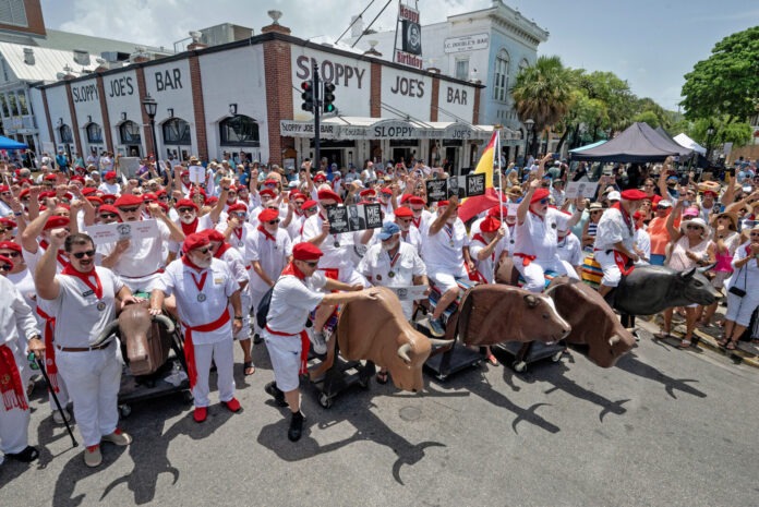 HemRunoftheBulls_01 a group of people dressed in white and red