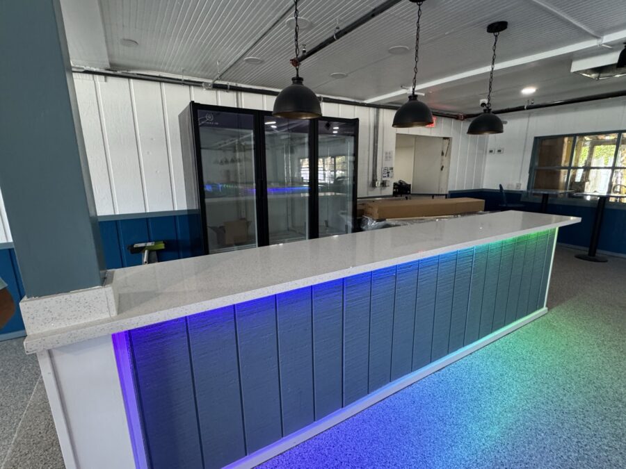 a long counter with a rainbow light on it