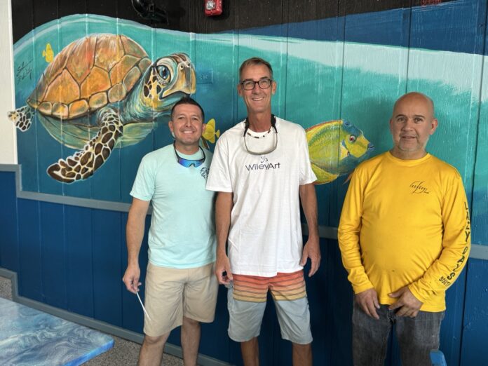 IMG_3089 Large three men standing in front of a mural of a turtle