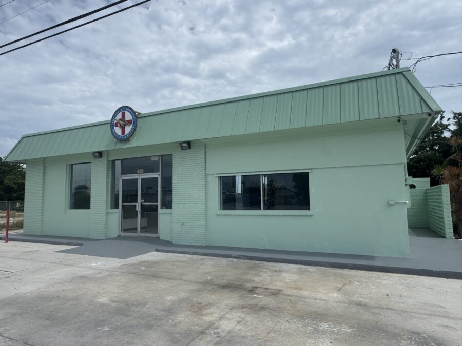 a green building with a sign on the front of it