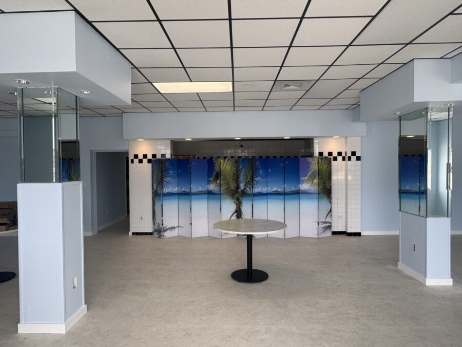an empty room with a round table in the middle