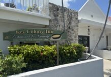 a white building with a sign that says key colony inn