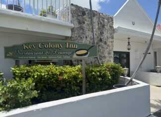 a white building with a sign that says key colony inn