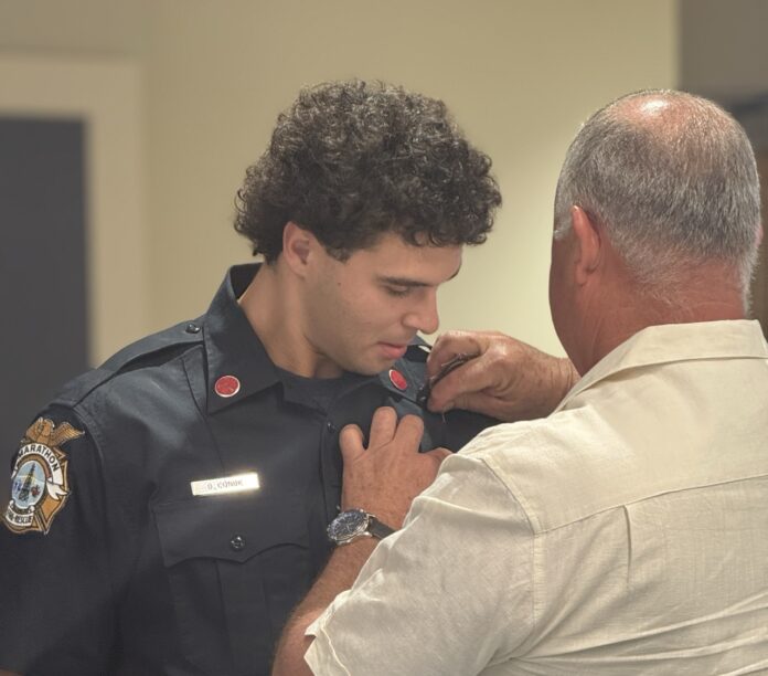 a police officer helping a man fix his tie
