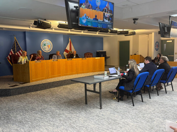 Monroe County Commission a group of people sitting around a conference room