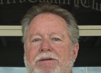 a close up of a person wearing a green shirt