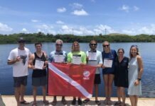 a group of people standing next to each other holding a flag