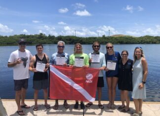 a group of people standing next to each other holding a flag