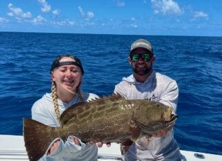 a couple of people on a boat with a fish
