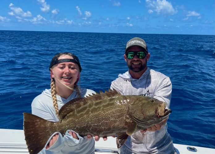a couple of people on a boat with a fish