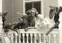a woman sitting on a porch with stuffed animals