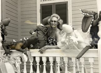 a woman sitting on a porch with stuffed animals