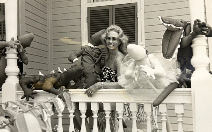 Judi and lizards Large a woman sitting on a porch with stuffed animals