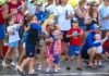 a crowd of people standing around each other