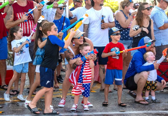 a crowd of people standing around each other