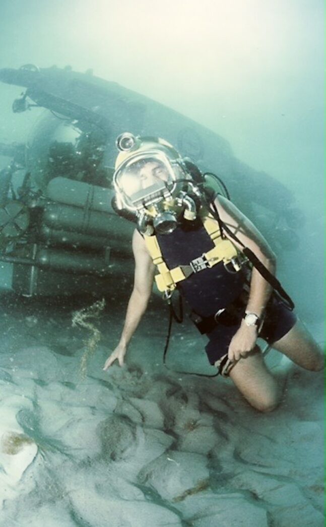 a man in a diving suit diving in the water