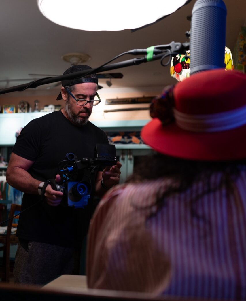 a man in a red hat is holding a camera