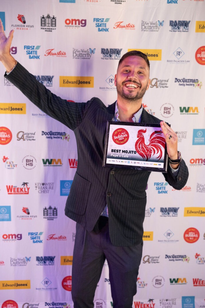 a man in a suit and tie holding a plaque