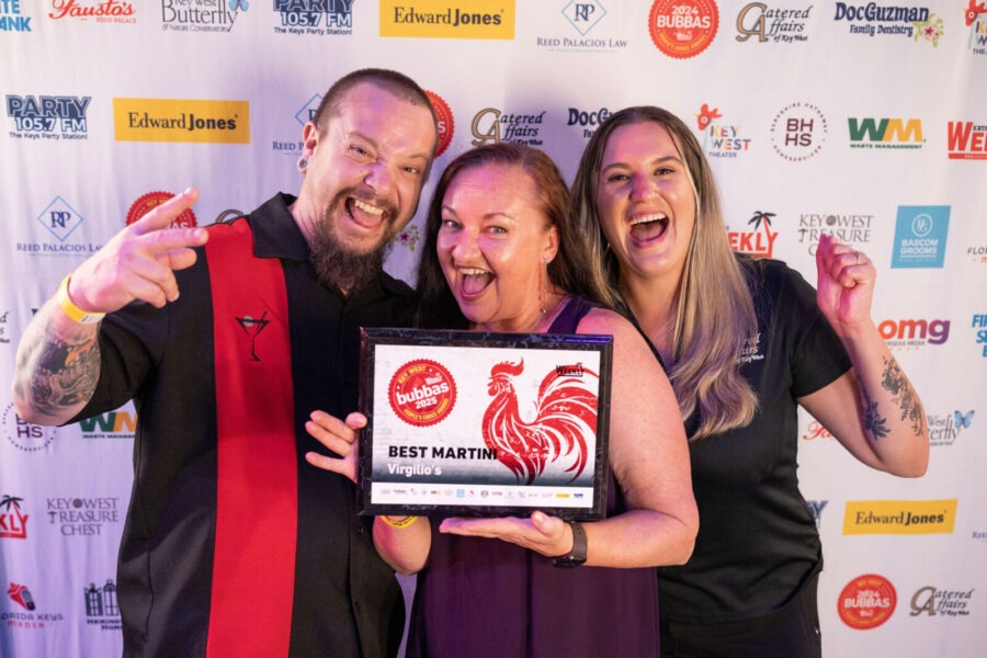a group of people standing next to each other on a red carpet