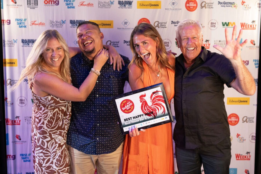a group of people standing next to each other on a red carpet