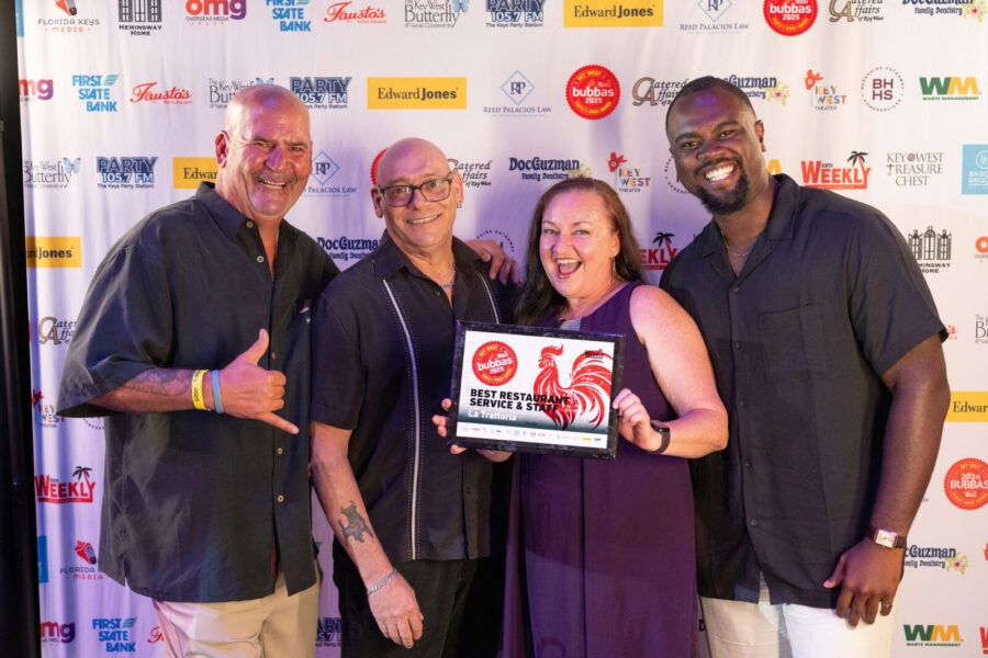 a group of people standing next to each other on a red carpet