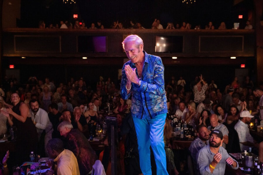 a man standing on a stage in front of a crowd