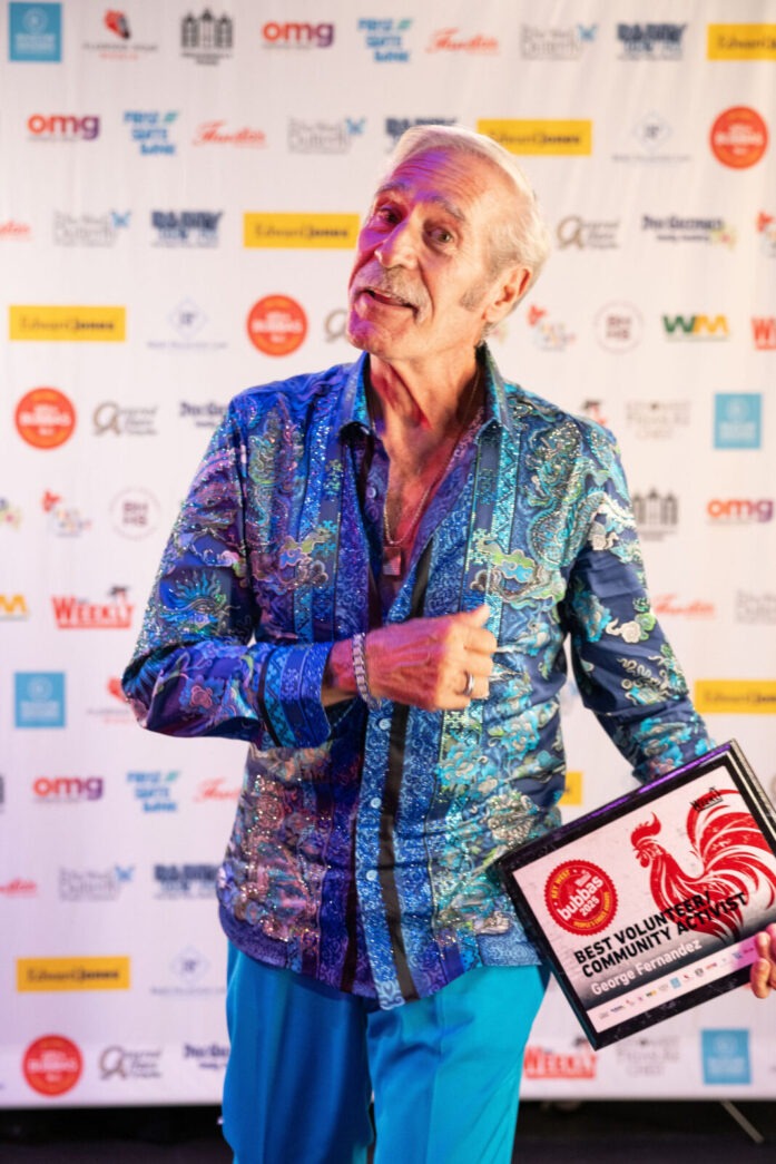 a man in blue pants holding a plaque