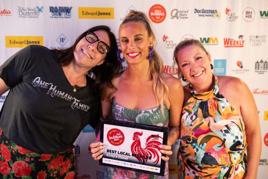 a group of women standing next to each other on a red carpet