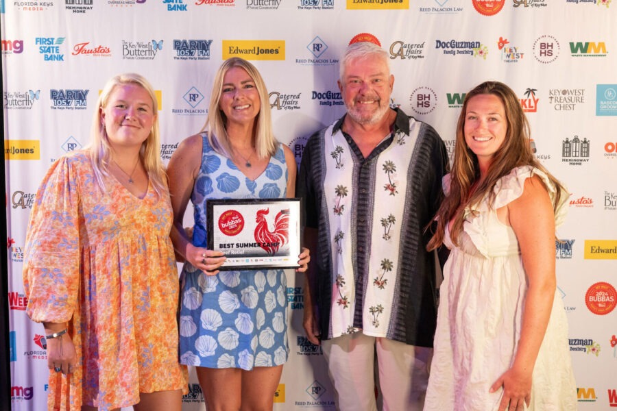 a group of people standing next to each other on a red carpet